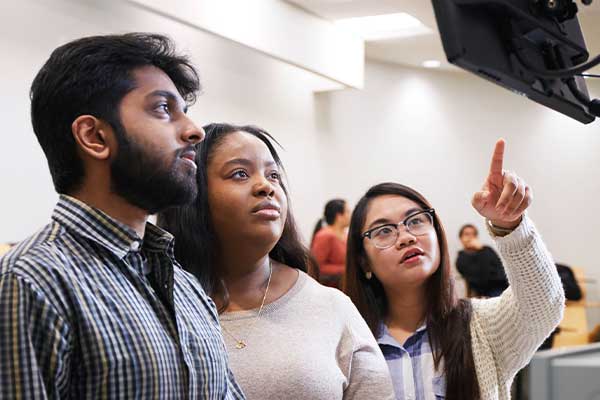 Students looking at a monitor