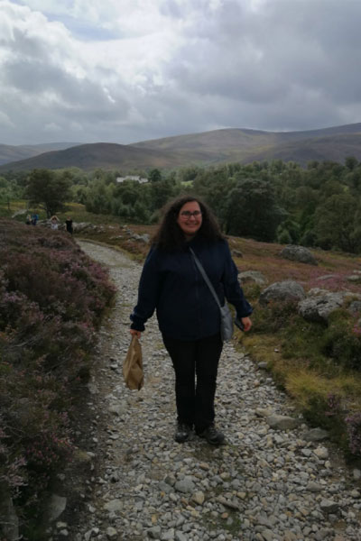 Alexandria Cozzolini walking on a trail in Scotland