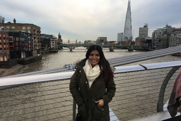 Maria Camila Ruiz Tacha standing on a bridge in England with the city behind her