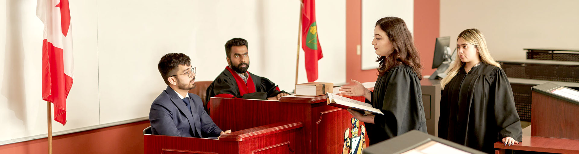 Four people in mock courtroom