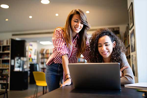 Two people looking at laptop