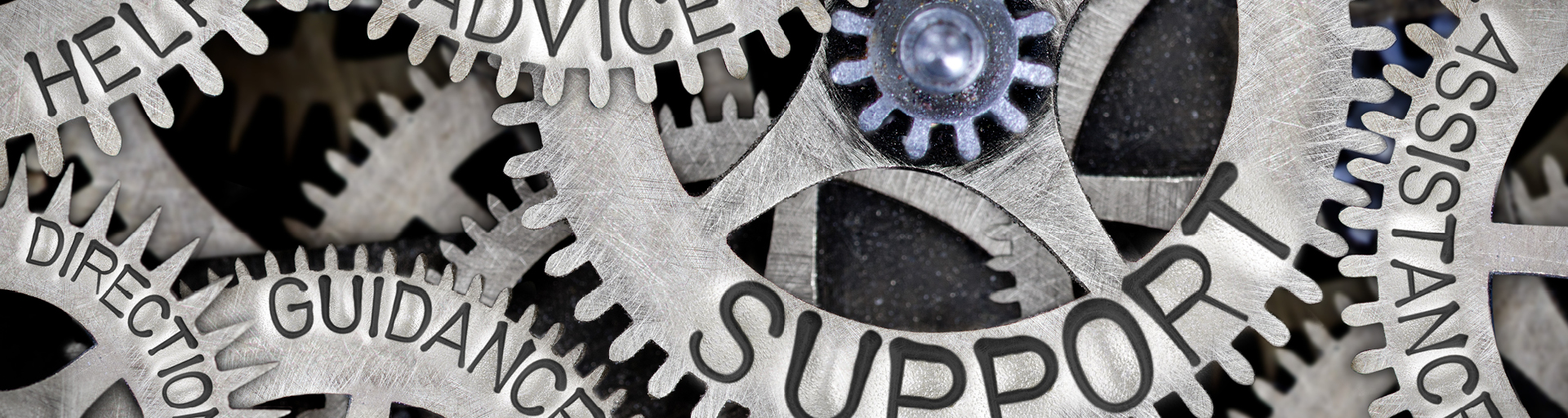 Macro photo of tooth wheels with SUPPORT, HELP, DIRECTION, ADVICE, GUIDANCE, ASSISTANCE imprinted on metal surface