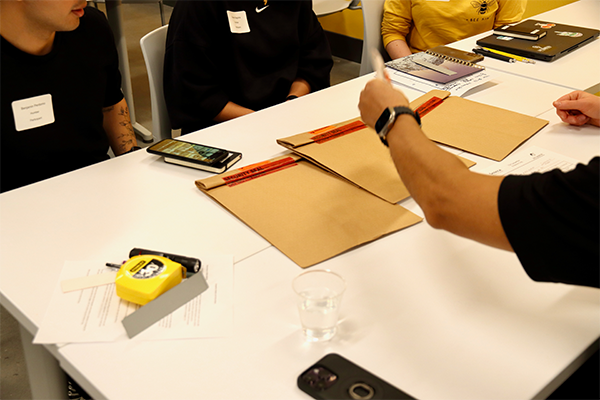 Students spreading documents on table