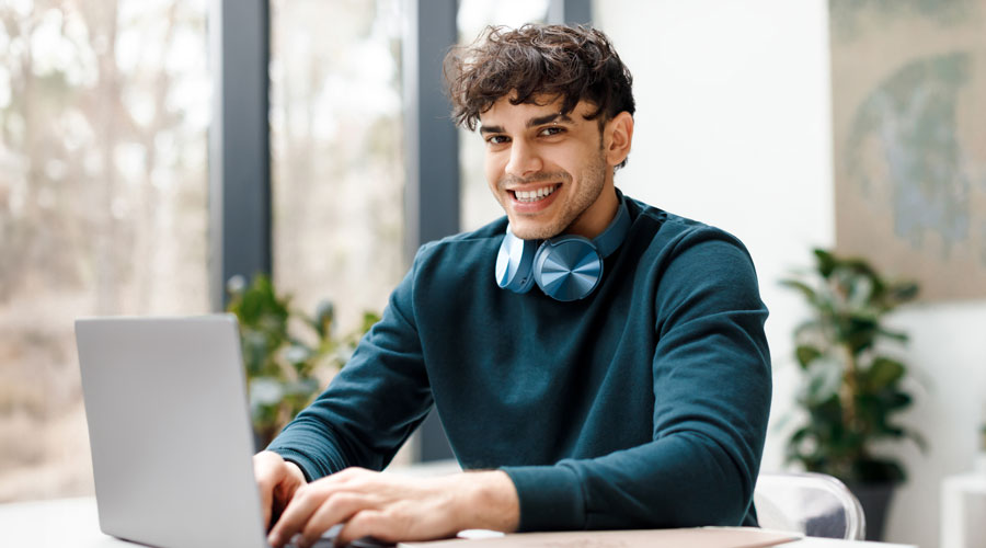 person sitting at a desk smiling