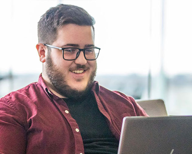 student in the Humber learning commons working on a laptop