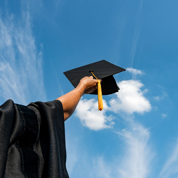 Person holding graduation cap
