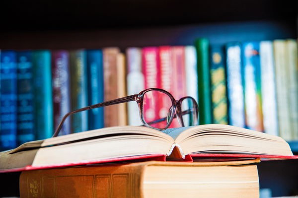 Close up shot of glasses on an open textbook