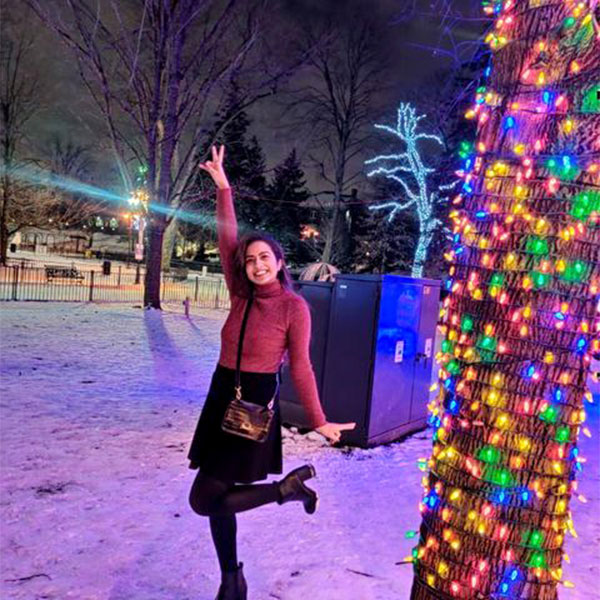 Prilina posing in front of christmas lights