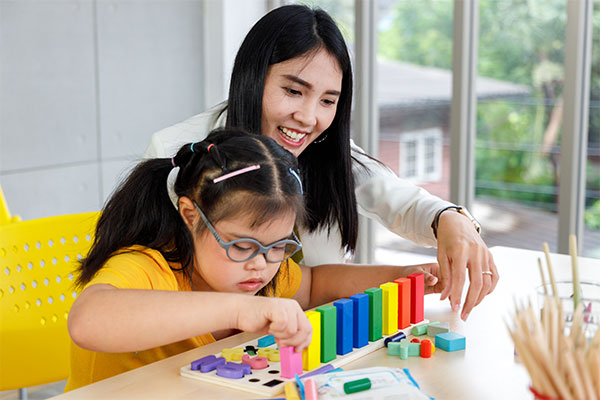 social worker observing a child playing with blocks