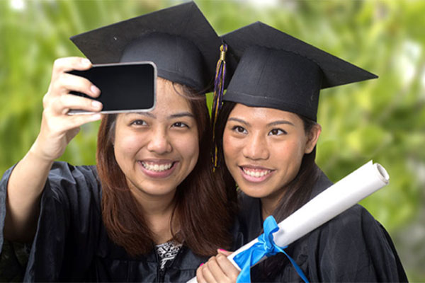 Two Students wearing graduation caps and gowns