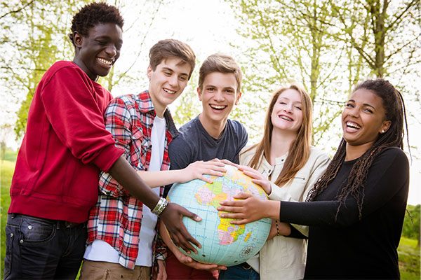 Group of students holding a globe