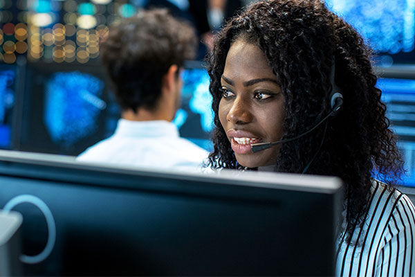 woman wearing a headset on the computer