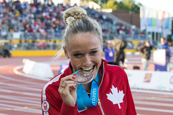 Sarah wells biting her olympic medal