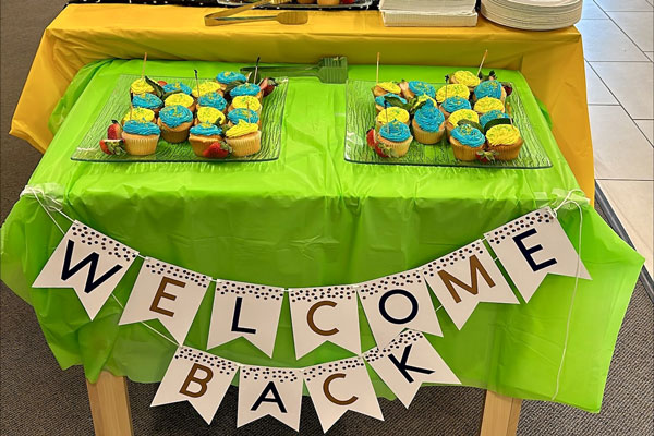 Table with food and sign that reads Welcome Back