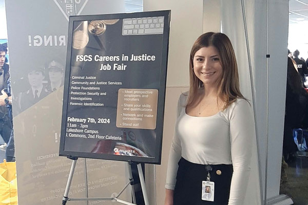 Person standing beside poster display at career fair