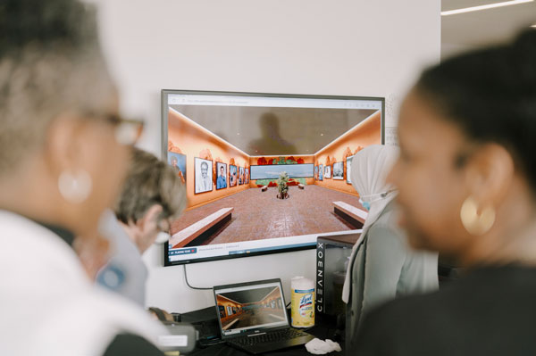 Two people looking at display screen at event