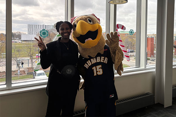 humber employee taking a photo with the mascot