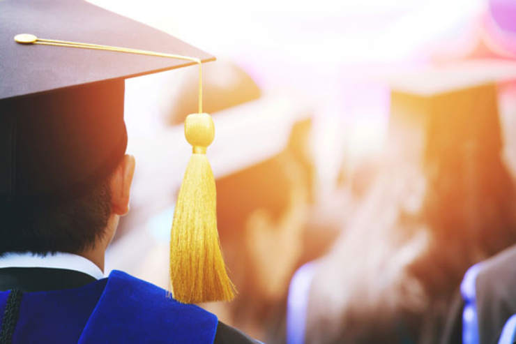 back of students wearing caps and gowns
