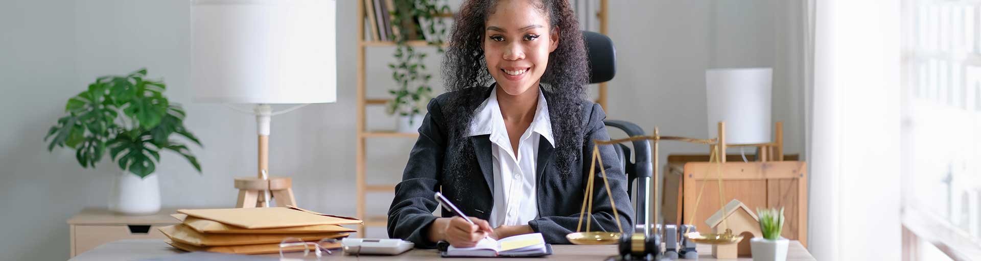 person sitting at a desk writing