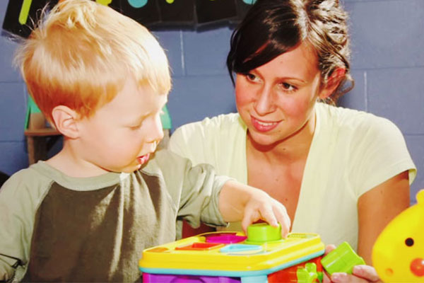 female teacher talking to small boy