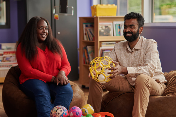 Two people in children's play room