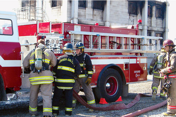 student firefighters standing in front of fire truck