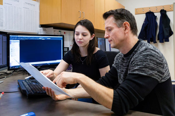 Student and instructor sitting at desk